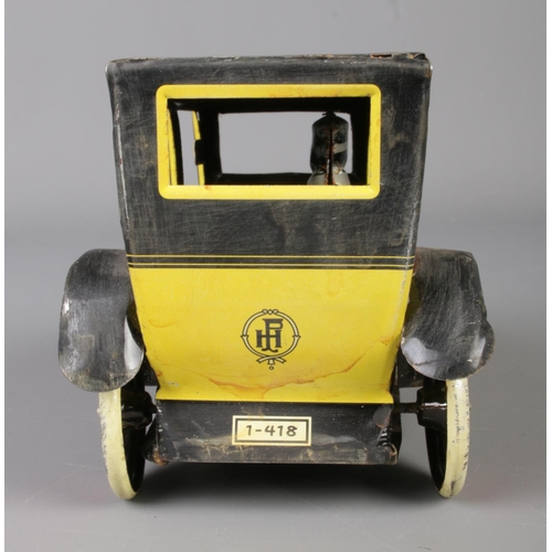 71 - A vintage Paya tin plate mechanical taxi along with a boxed Japanese tin plate Ford-A Touring Conver... 