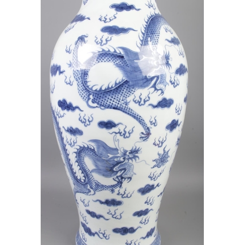 3 - A large Chinese baluster shaped floor vase/table lamp. Decorated in under glaze blue with Kylins and... 