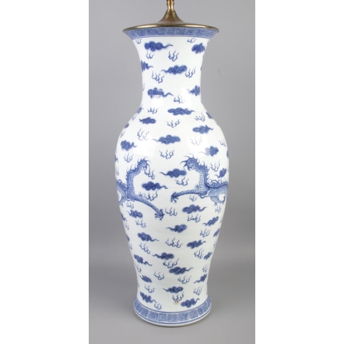 3 - A large Chinese baluster shaped floor vase/table lamp. Decorated in under glaze blue with Kylins and... 