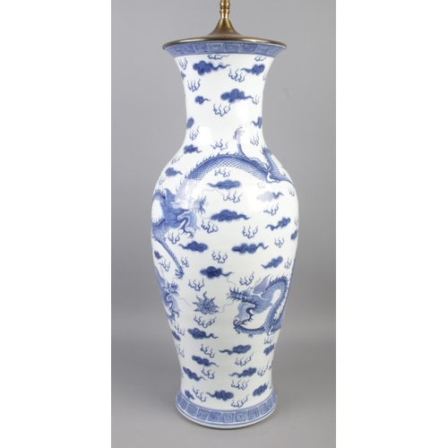 3 - A large Chinese baluster shaped floor vase/table lamp. Decorated in under glaze blue with Kylins and... 