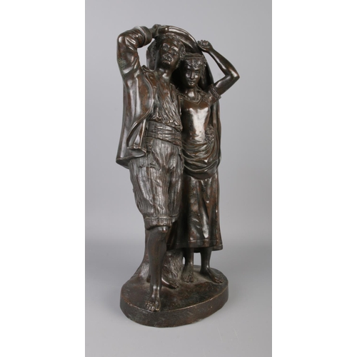 34 - Fernand Lorrain (19th century), a bronze figure group modelled as a couple sheltering from the rain.... 