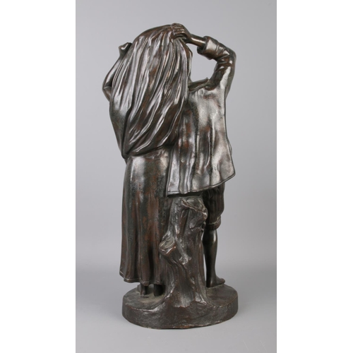 34 - Fernand Lorrain (19th century), a bronze figure group modelled as a couple sheltering from the rain.... 