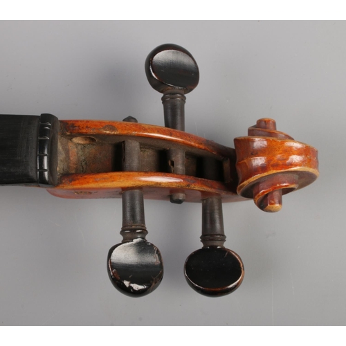 50 - A 19th century violin. Having 12inch two piece back and bearing spurious label 'Antonius Stradivariu... 