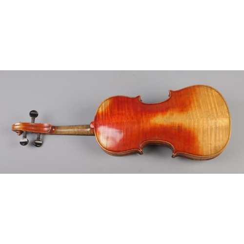 50 - A 19th century violin. Having 12inch two piece back and bearing spurious label 'Antonius Stradivariu... 