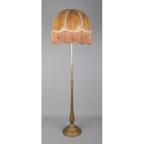 42 - A brass rise and fall table lamp in the style of Benson with fringed shade.