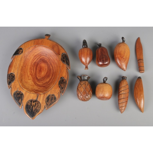 279 - A mid-century vintage hand-carved wooden fruit bowl containing eight pieces, bowl size 32x22cm.