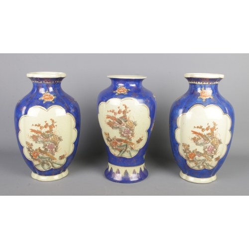 287 - A set of three oriental vases, decorated with gilt foliage, flowers and pheasants, tallest 32cm.