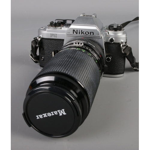 261 - A Nikon FG SLR camera in chrome along with a selection of lenses to include Vivitar MC Tele Converte... 