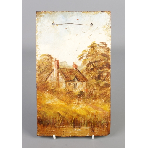 290 - A hand painted terracotta plaque. Decorated with a landscape scene and cottage. Impressed Victoria t... 