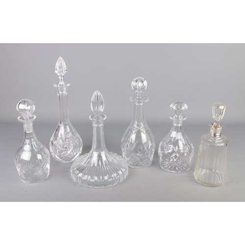 280 - Six cut glass decanters one having a silver top all with stoppers on a silver plate tray with a quan... 