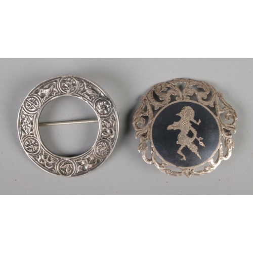 478 - A Scottish silver brooch with zoomorphic design together with a Siam silver brooch.

18.77g