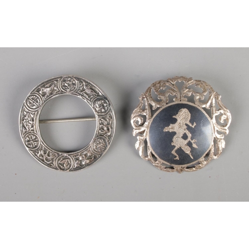 478 - A Scottish silver brooch with zoomorphic design together with a Siam silver brooch.

18.77g