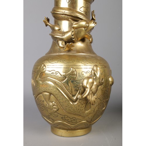 266 - A pair of early Twentieth Century Chinese polished brass vases decorated with coiled dragons. Bearin... 