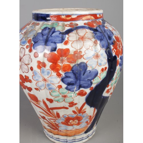 270 - A pair of Chinese lidded vases, decorated with Prunus blossom in blues and oranges, with pointed fin... 