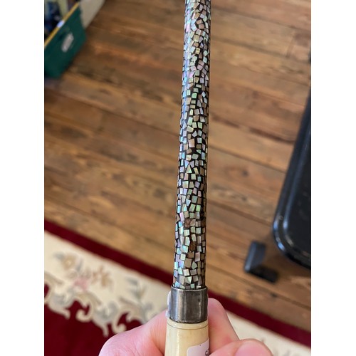 51 - A ladies abalone set walking cane with bone pommel and white metal mounts. Length 87cm.