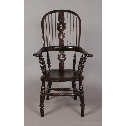 600 - A 19th century ash/elm Windsor arm chair. With pad arms and pierced splat back. Height of back 115cm... 