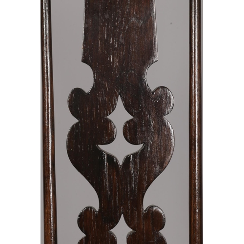 600 - A 19th century ash/elm Windsor arm chair. With pad arms and pierced splat back. Height of back 115cm... 