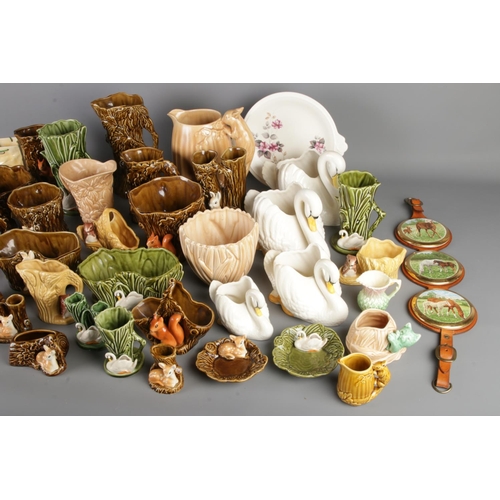 11 - A very large quantity of Sylvac Pottery including swans, woodland creatures, vases etc including mod... 