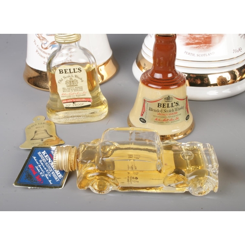 153 - A collection of sealed alcohol to include four Bells whisky bells, Kenmore whisky miniature formed a... 