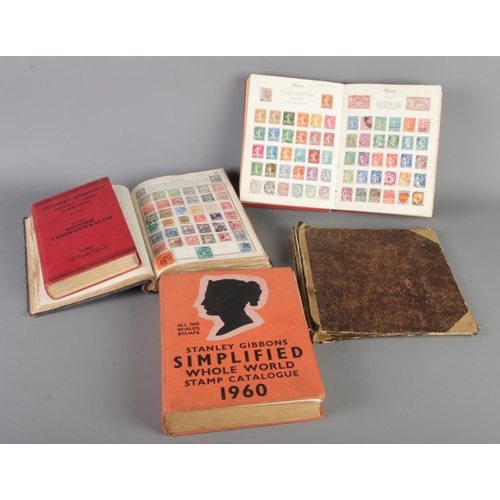 165 - A collection of three vintage world stamp albums with two Stanley Gibbons catalogues (1960/1963). St... 