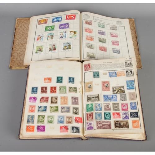 165 - A collection of three vintage world stamp albums with two Stanley Gibbons catalogues (1960/1963). St... 