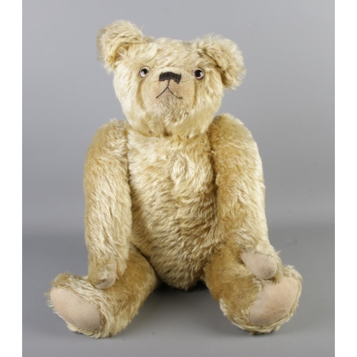 An early 20th century Farnell mohair jointed bear. With growler. Seated height 43cm.