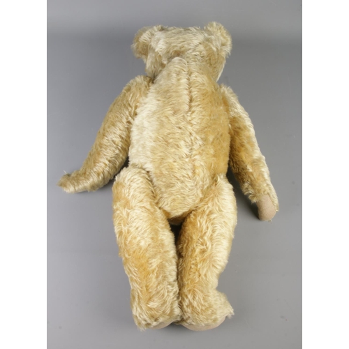 2 - An early 20th century Farnell mohair jointed bear. With growler. Seated height 43cm.