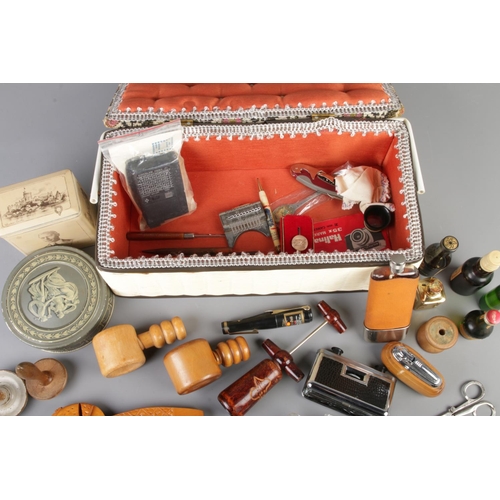 30 - A sewing box filled with mixed collectables including wooden nutcrackers, corkscrews, tasco binocuar... 