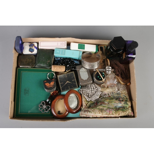 39 - A tray of collectables. Includes photograph frames, perfume bottles, paua shell clip on earrings, Sw... 