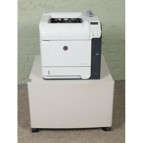 A HP Laserjet Enterprise 600 M603 printer along with a short metal ...