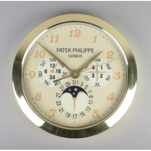 380 - A Patek Philippe watch style wall clock, featuring a gold bezel and gold dial featuring Arabic Numer... 