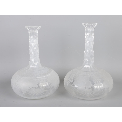 8 - A Victorian cut glass claret decanter (H40cm) with a pair of Victorian engraved decanters (H22cm) .
