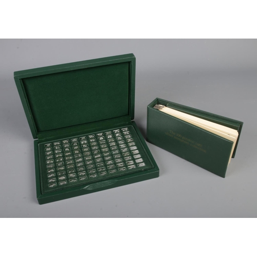 423 - The John Pinches '100 Greatest Cars' silver miniature collection in fitted case along with folder in... 