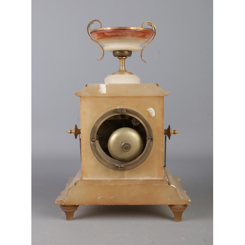 14 - An antique alabaster clock garniture, consisting of urn topped centrepiece, with chain link and cent... 