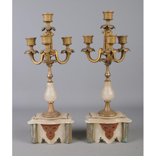 14 - An antique alabaster clock garniture, consisting of urn topped centrepiece, with chain link and cent... 