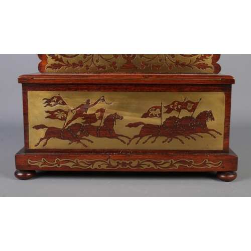 16 - A Nineteenth century rosewood and brass inlaid mantel clock casing of octagonal form, featuring scro... 