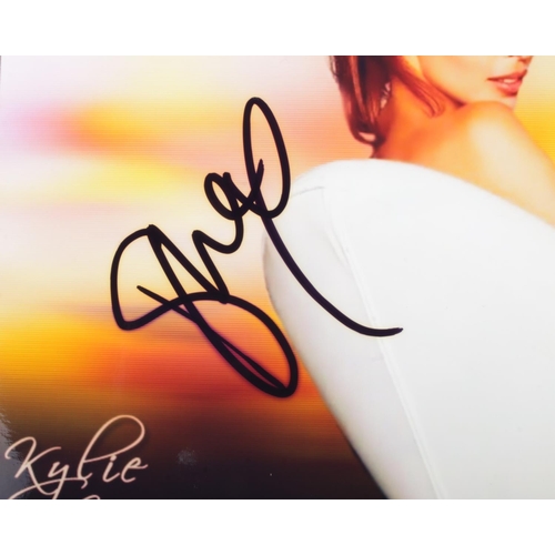 17 - A Kylie Minogue signed colour photograph with Certificate of Authenticity. Approx. dimensions 25.5cm... 
