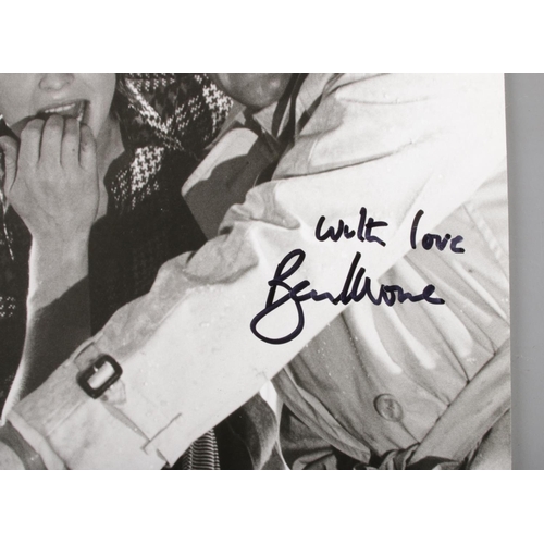 7 - A Roger Moore signed monochrome film still. Approx. dimensions 19.5cm x 25cm.