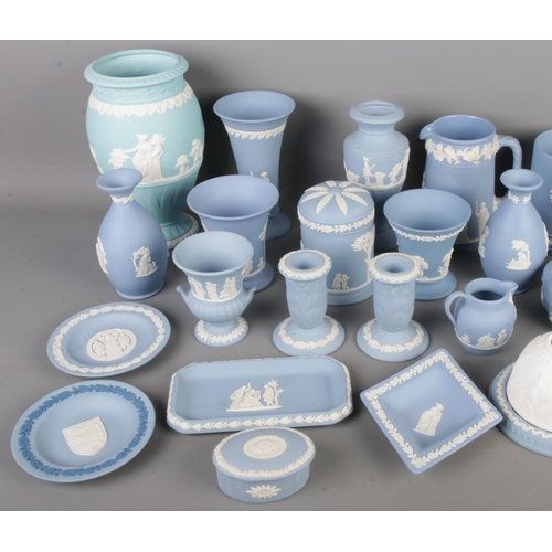 12 - A collection of twenty-eight blue Wedgwood Jasperware items, including trinkets, lidded boxes, vases... 
