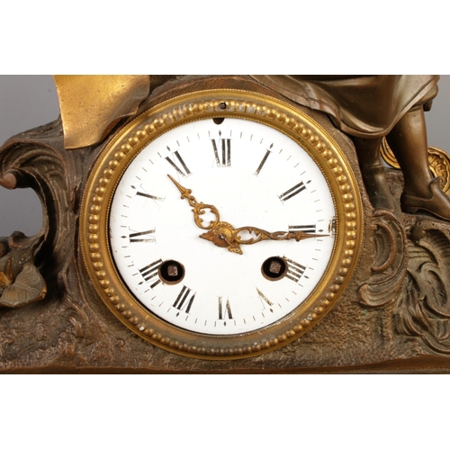 13 - An antique French bronze and slate mantel clock, with a bronze figure seated beside pillars and scro... 