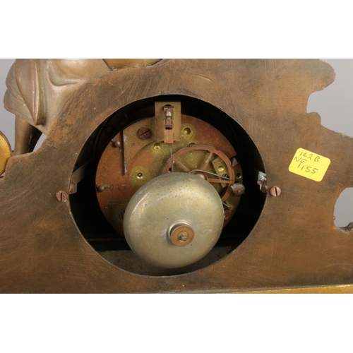 13 - An antique French bronze and slate mantel clock, with a bronze figure seated beside pillars and scro... 