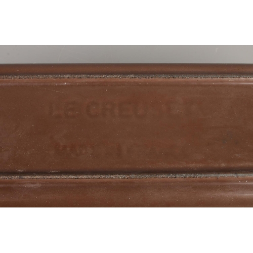 19 - A Le Creuset cast iron terrine dish, in chocolate brown. Length: 31cm, Width: 11cm, Depth: 8cm.
