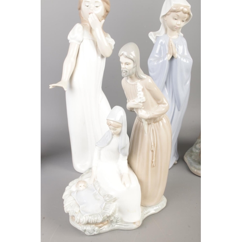 29 - A collection of Nao by Lladro ceramic figures to include Mary and Joseph figure group, table lamp fo... 