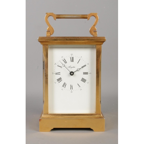 3 - A brass Angelus carriage clock, with key. Featuring open top escapement, 11 jewel movement and Roman... 
