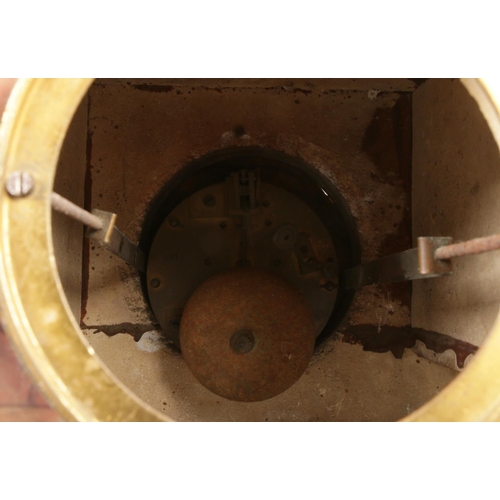 32 - A red marble mantel clock topped with spelter sculpture figures depicting a traditional blacksmithin... 