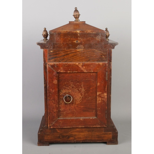 33 - A 19th century German mantel clock by Junghans, featuring three circular finials on the walnut case ... 