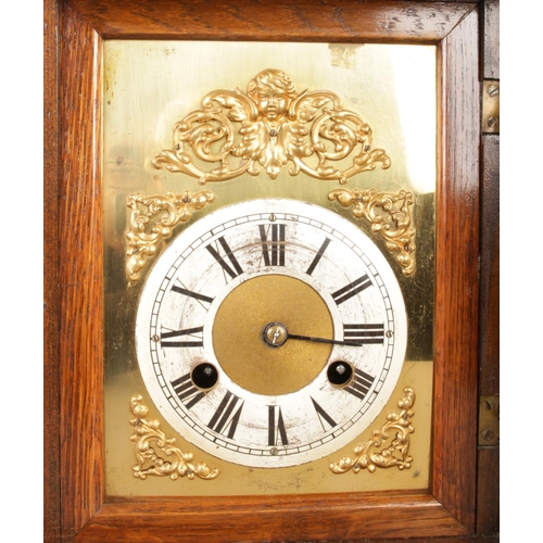 33 - A 19th century German mantel clock by Junghans, featuring three circular finials on the walnut case ... 