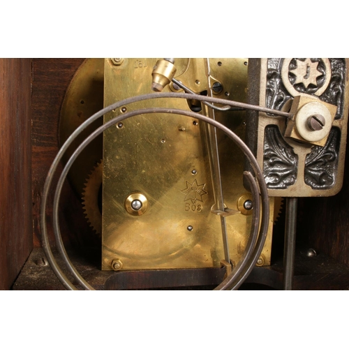 33 - A 19th century German mantel clock by Junghans, featuring three circular finials on the walnut case ... 