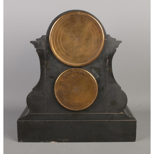 35 - A late 19th century black slate mantel clock with barometer, featuring a visible escapement within a... 