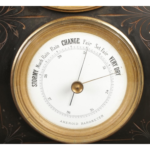 35 - A late 19th century black slate mantel clock with barometer, featuring a visible escapement within a... 